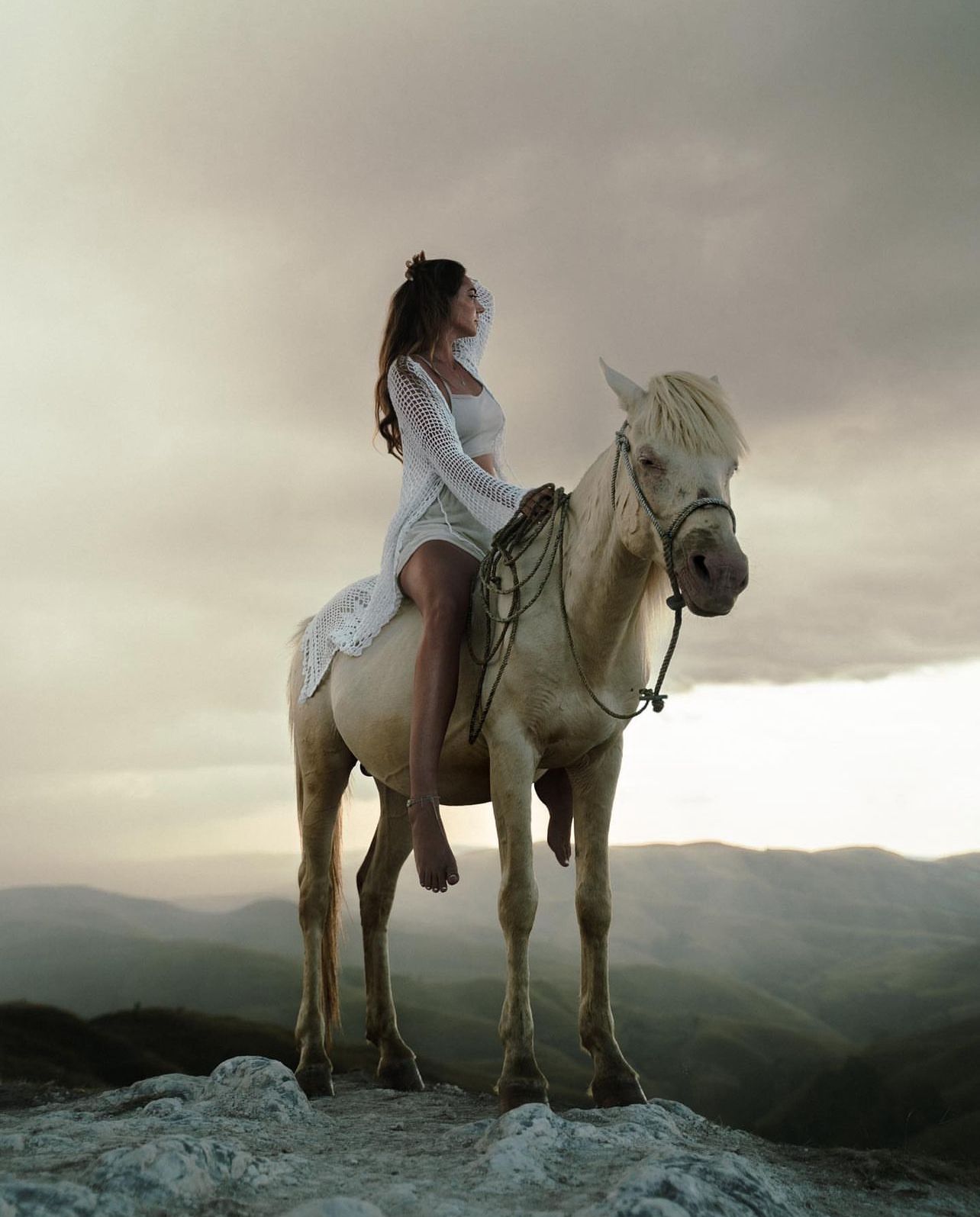 Susanne on horseback above the cliffs of Sumba